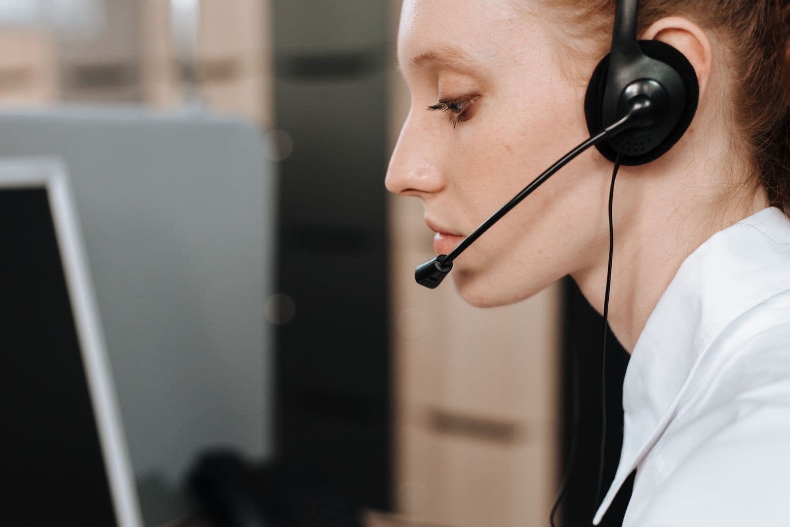 Woman with a headset working at a screen